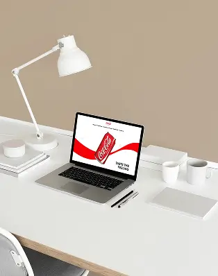 Creative web designer showcasing Coca-Cola Guam and Micronesia website design, highlighting a clean, user-friendly interface by Wave & Wonder.